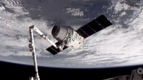 Space station astronauts floated into the Dragon on Saturday, a day after its heralded arrival as the world's first commercial supply ship.